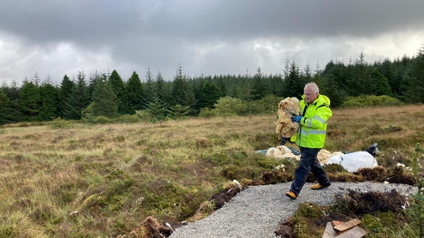 Frank McMahon carries wool to be used on the trail