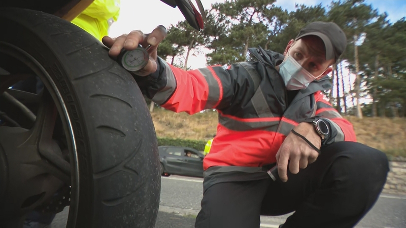 A member of the RSA carries out a tyre check demonstration at Chapelizod in Dublin