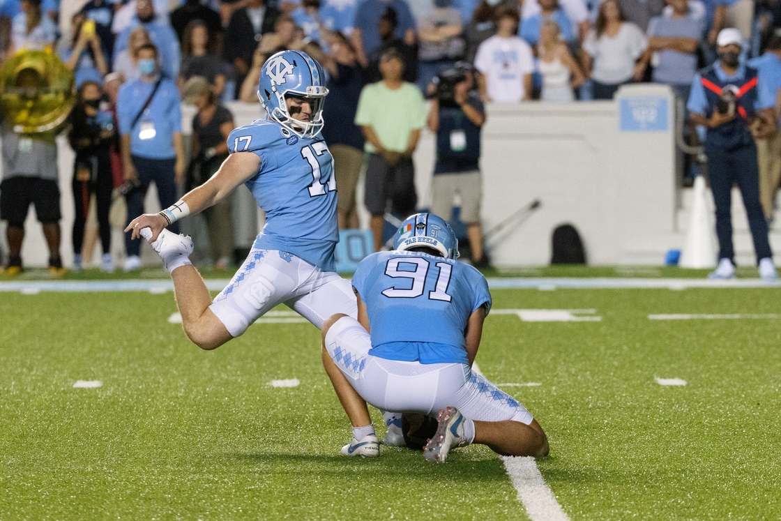 Kiernan #91 holds the ball for a team-mate during a game against Georgia State on 11 September