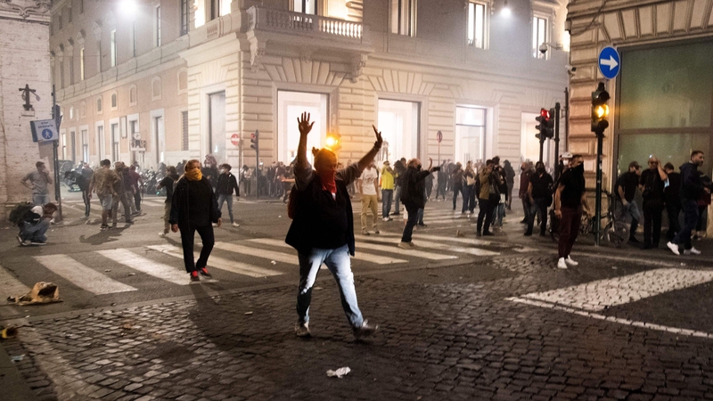 People take part in a protest against the mandatory pass