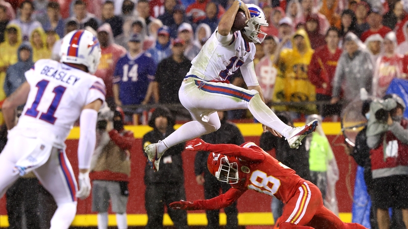 Buffalo Bills quarterback Josh Allen hurdles Kansas City Chiefs cornerback L'Jarius Sneed as he rushes for a first down