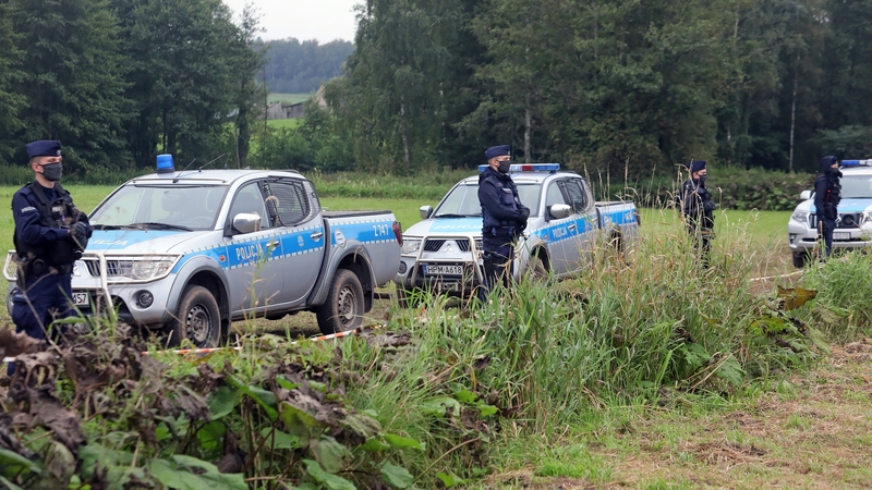 Armed polish police officers stand at the Polish-Belarusian border near Usnarz Gorny village in north-west Poland