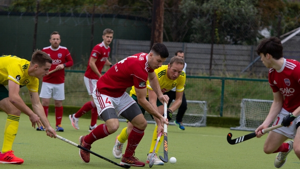 Cookstown's Ryan Millar (red jersey) under pressure from Rob Abbott of Railway Union