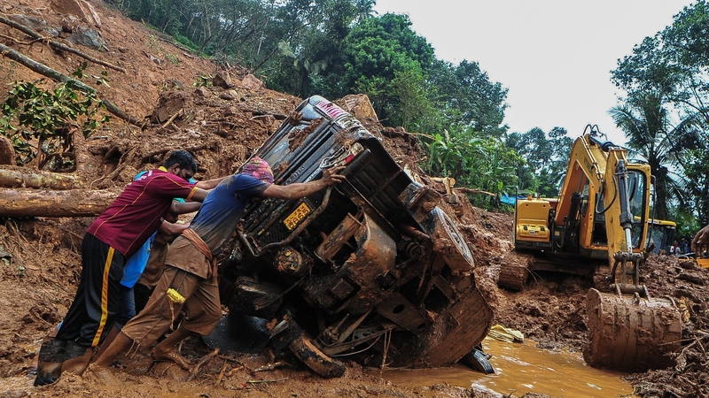 Rescue workers at a site of a landslide in Kokkayar in India's Kerala state