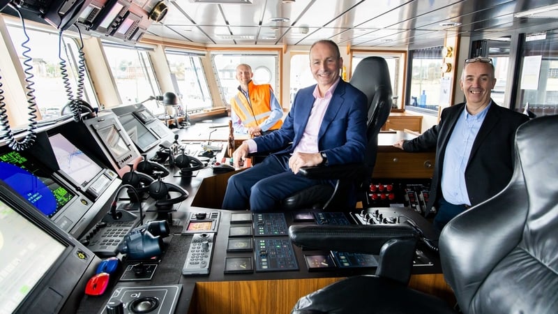 Taoiseach Micheál Martin joins John Wallace (R) Green Rebel CEO and Chris Franks (L) Senior Master of the Roman Rebel vessel