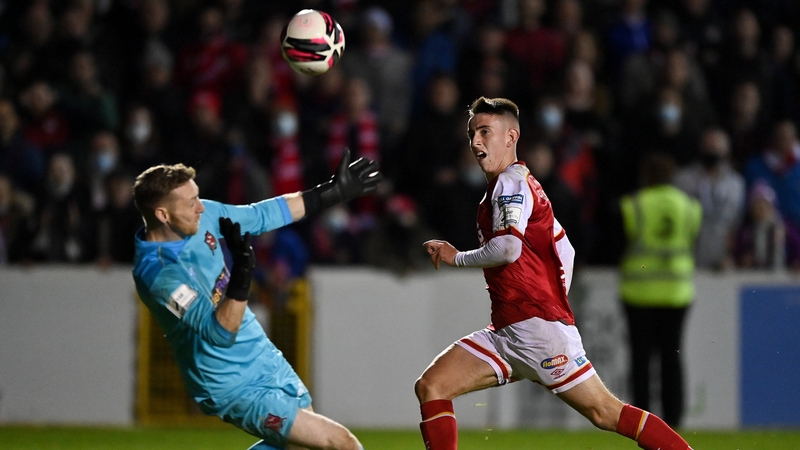 Darragh Burns chipping the Dundalk goalkeeper to score the third