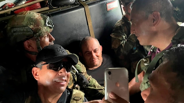 Colombian soldiers pose for photos with Dairo Antonio Usuga after his arrest