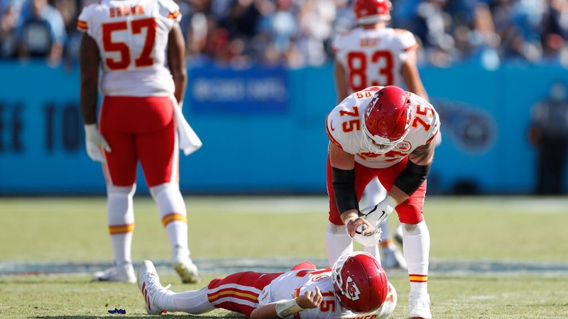 Patrick Mahomes (15) is helped off the field by Mike Remmers (75) in the fourth quarter