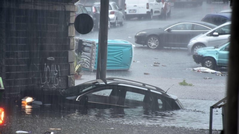 A car is submerged in floodwaters in Catania after heavy rain in sicily