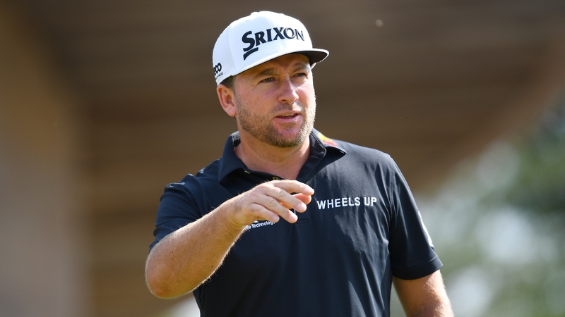 Graeme McDowell carded a bogey-free 68 to trail leader Ben Martin by two shots.