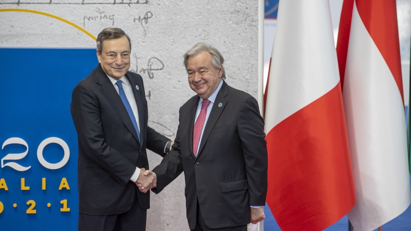 United Nations Secretary-General Antonio Guterres (R) is welcomed by Italian Prime Minister Mario Draghi