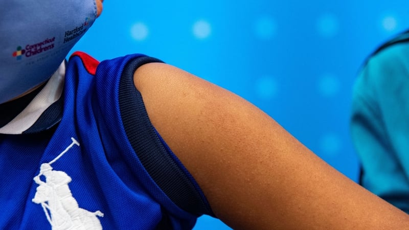 A six-year-old boy waits to receive the Pfizer-BioNTech vaccine at Hartford Hospital in Hartford, Connecticut