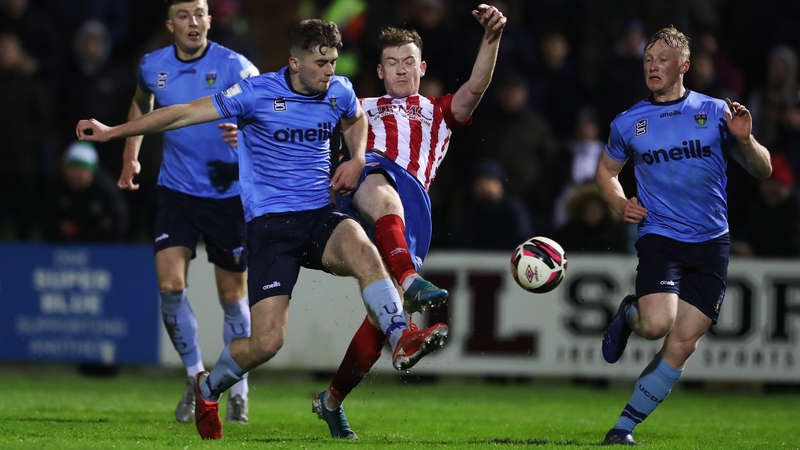 Jack Lynch of Treaty United in action against Harvey O'Brien of UCD