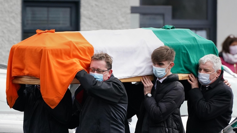 The coffin carrying the remains of Austin Currie are carried into the church