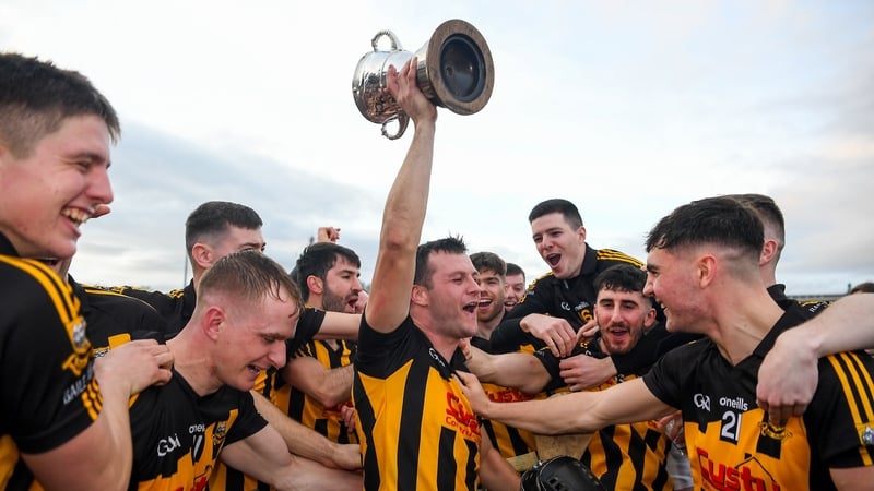 Ballyea captain Jack Browne, centre, and his team-mates celebrate with the Canon Hammilton Cup