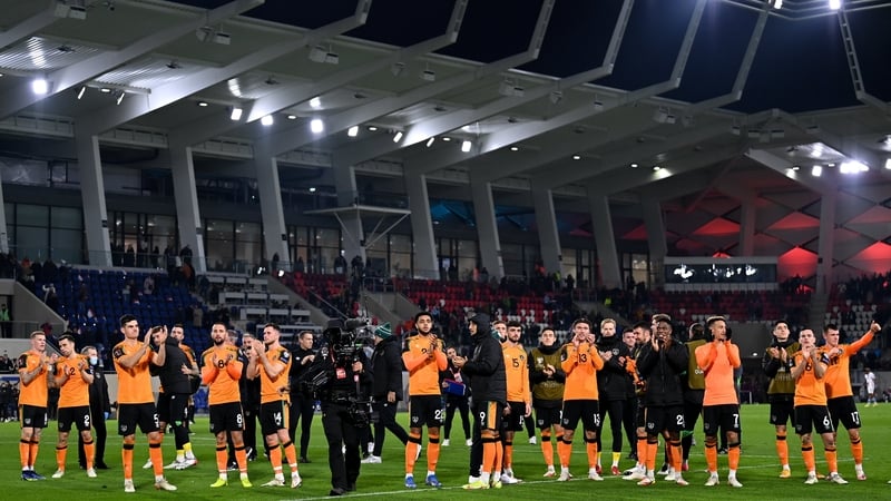 The players celebrate with the travelling support after the game