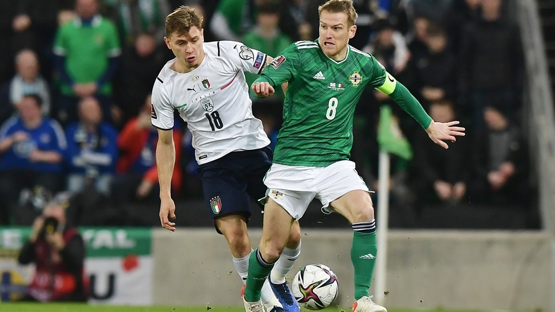 Steve Davis holds off the challenge of Italy's Nicolo Barella during the draw at Windsor Park