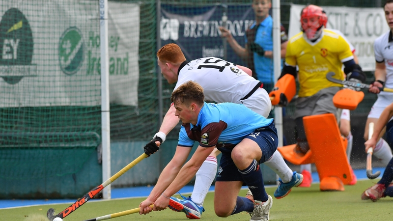 Three Rock Rovers' Ali Empey shoots under pressure from YMCA's Ben O'Grady