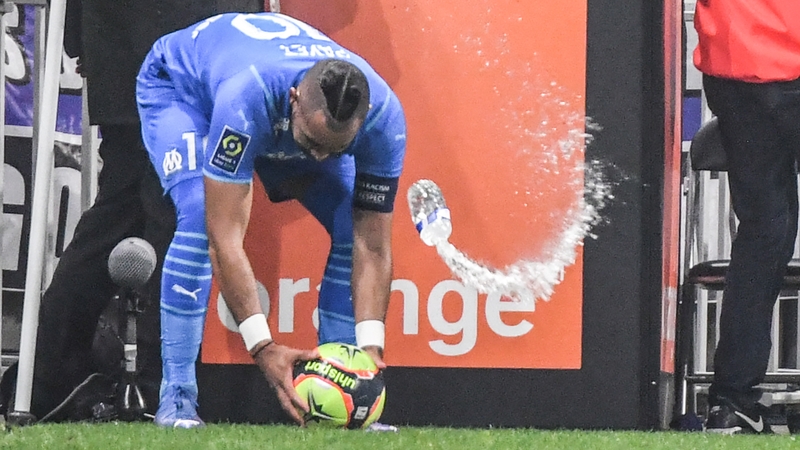 Marseille's French midfielder Dimitri Payet is hit by a bottle of water