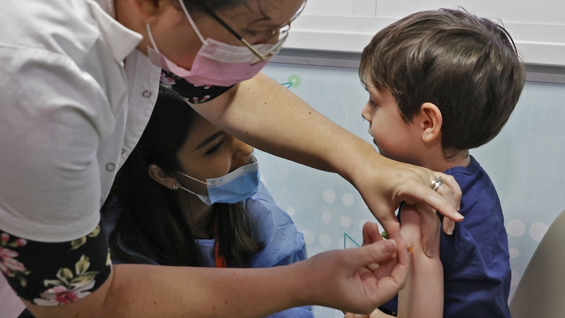 A 5-year-old boy receives the Pfizer/BioNTech Covid-19 vaccine at the Meuhedet Healthcare Services Organisation in Tel Aviv