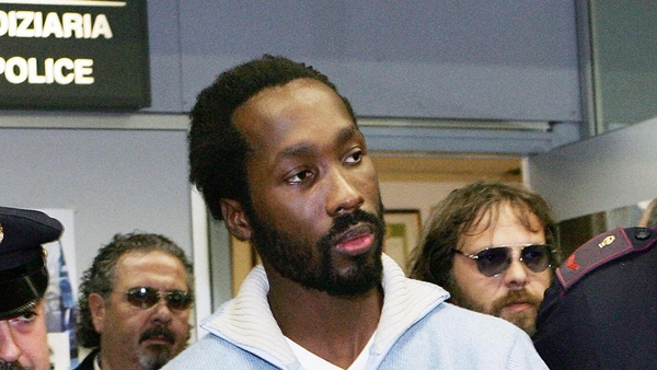 Rudy Guede pictured as he arrived at Rome's Fiumicino Airport in 2007 after being extradited from Germany
