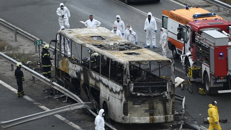 Officials work at the site of the bus crash on a highway near the village of Bosnek, south of Sofia