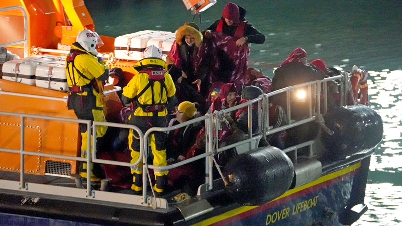 A group of migrants are brought to Dover by the RNLI