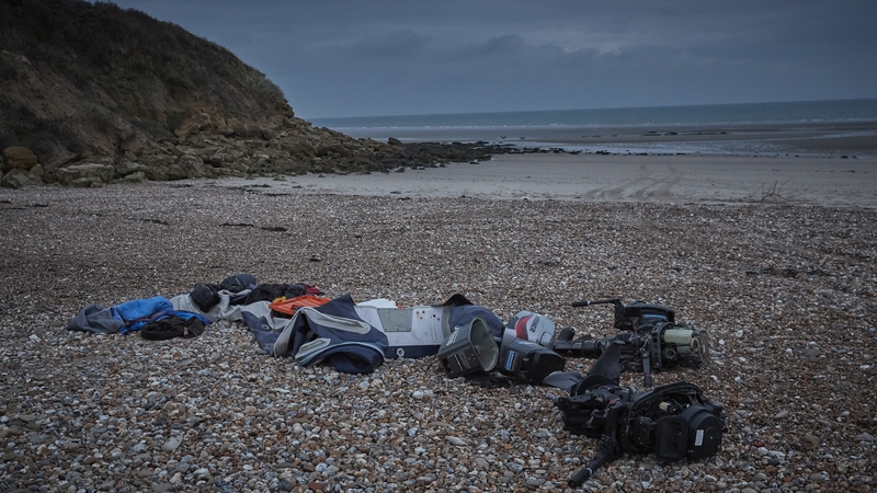 Belongings of migrants, a deflated dinghy, life jacket and engines, lie on the beach of Wimereux today in Calais
