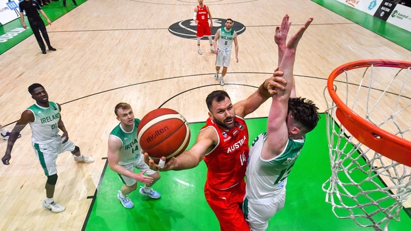 Austria's Jozo Rados goes for a basket despite the efforts of Jordan Blount