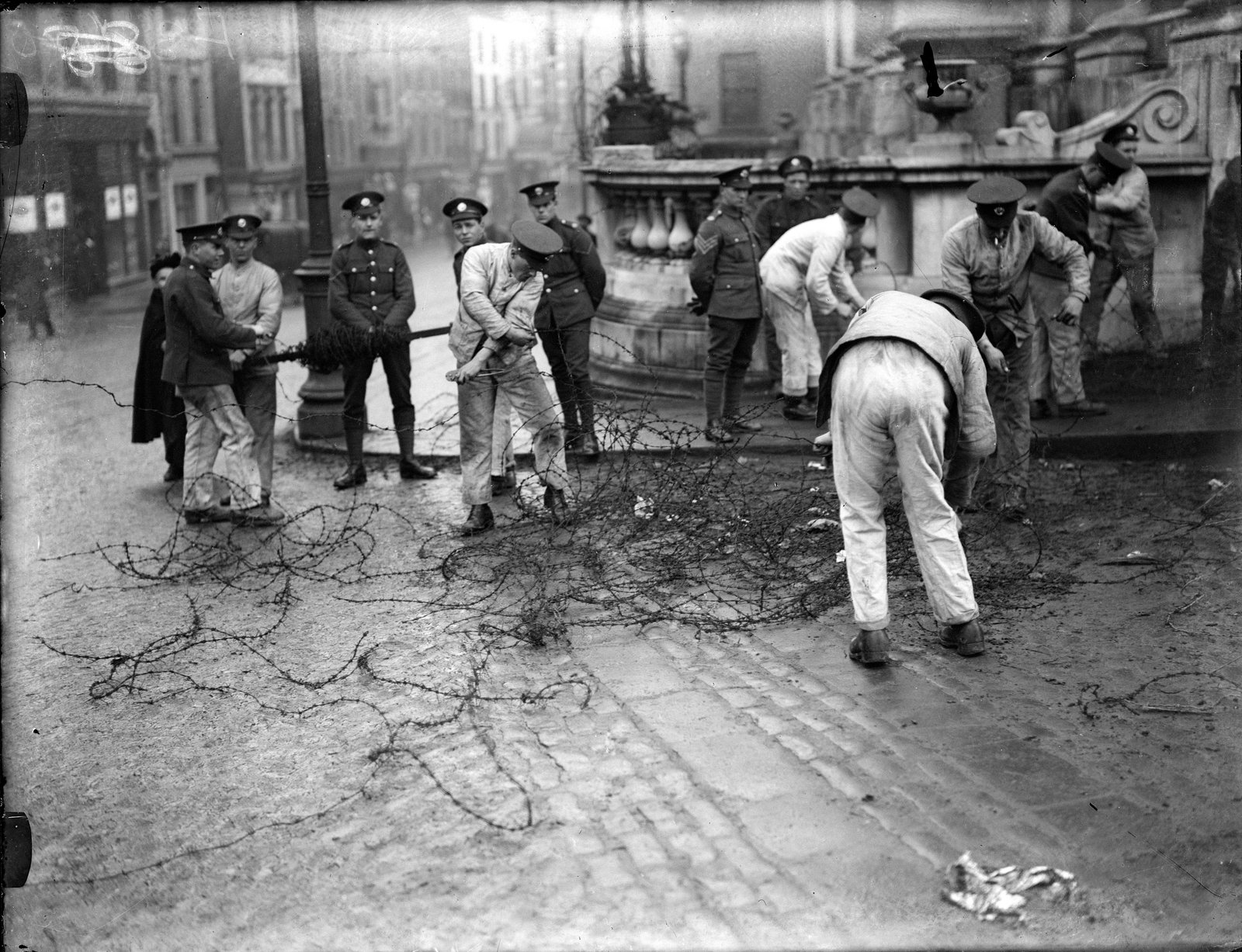 British troops in work fatigues dismantle the barriers and bunkers around Dublin Castle. Credit: Cashman Collection