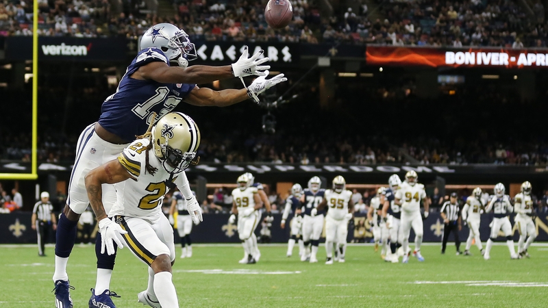 Michael Gallup of the Dallas Cowboys attempts to make a catch over Bradley Roby
