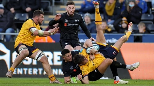 Ethan McIlroy is brought to ground by Owen Watkin in Liberty Stadium
