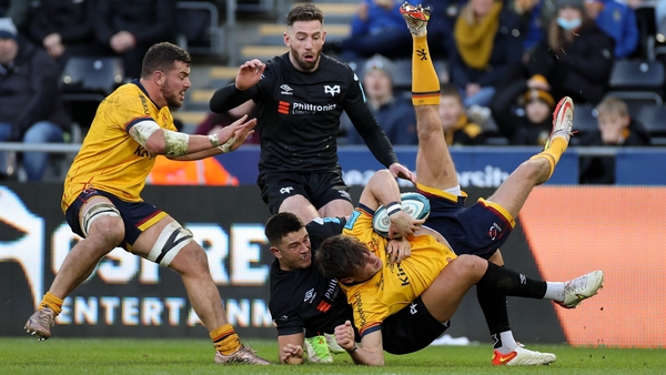 Ethan McIlroy is brought to ground by Owen Watkin in Liberty Stadium