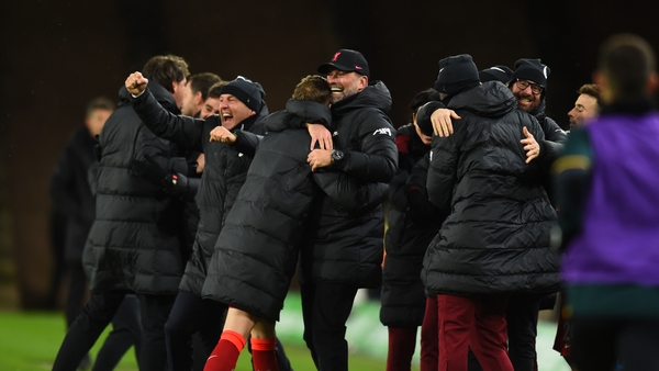 Jurgen Klopp and the Liverpool coaches and substitutes celebrate Divock Origi's late winner at Wolves