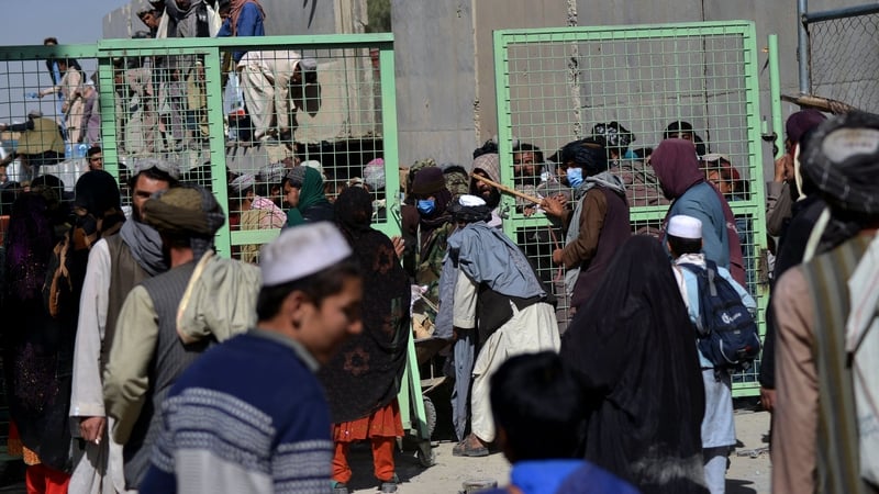 People wait to cross into Pakistan at the border with Afghanistan