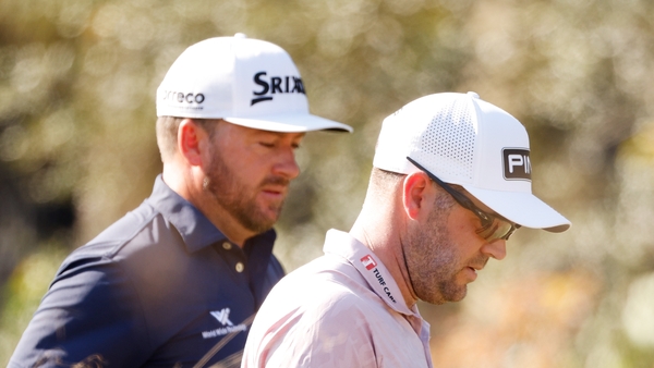 Graeme McDowell (L) and Corey Conners on the third hole at the Tiburon Golf Club event
