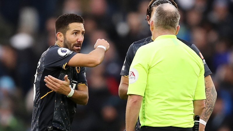 Joao Moutinho of Wolves pleads with referee Jonathan Moss after a penalty was awarded against him