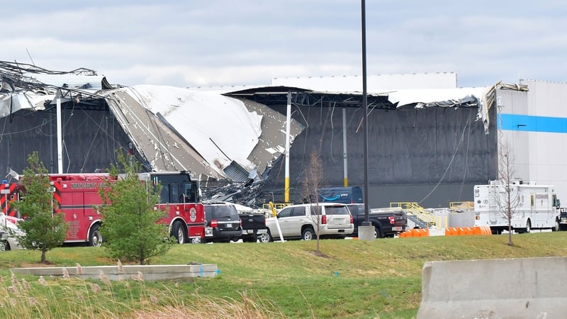 Workers remove debris from an Amazon Fulfillment Centre in Edwardsville, Illinois