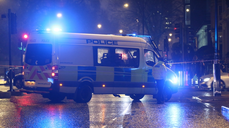 Police officers are seen at scene after a man was shot dead by police