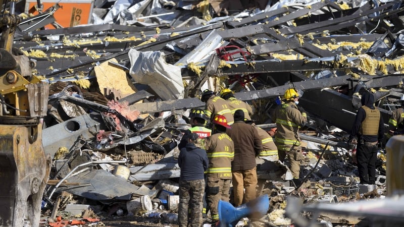 Emergency workers search through what is left of the Mayfield Consumer Products Candle Factory