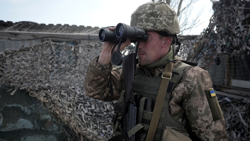 An Ukrainian serviceman patrols at the checkpoint in the village of Shyrokyne near Mariupol, the last large city in eastern Ukraine