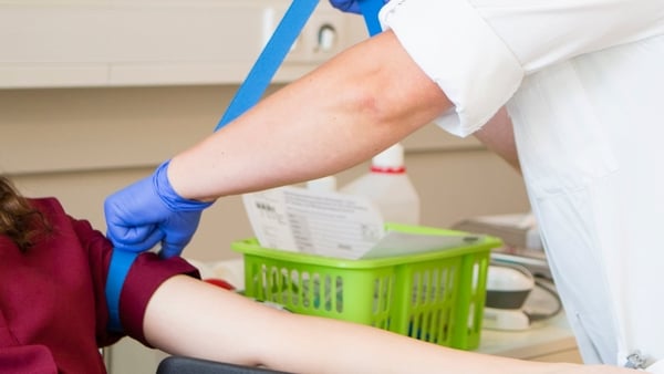 Young woman being prepared by a nurse for blood donation