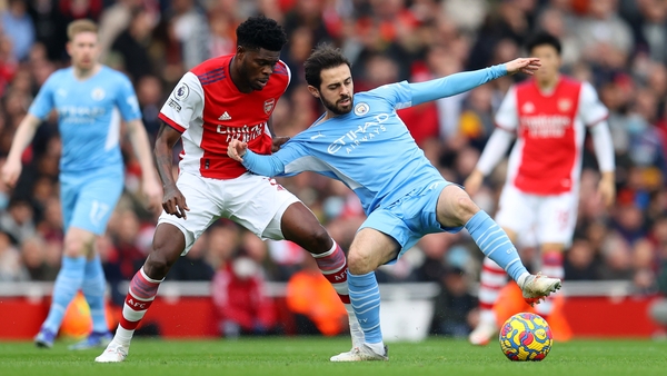 Bernardo Silva (R) holds off Thomas Partey