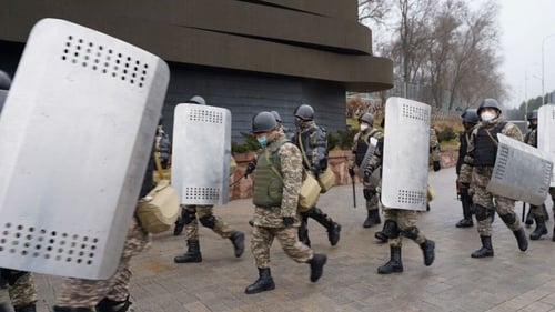 Riot police officers patrol the streets in Almaty