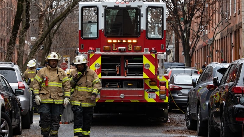 Fire fighters are pictured near the scene of the fatal fire in the Fairmount area of Philadelphia