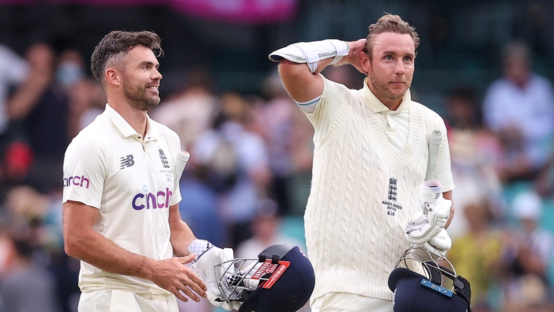 England's Stuart Broad (R) and James Anderson react as they walk off the ground at the end of play
