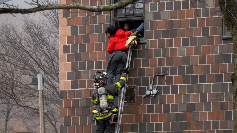 Firefighters hoisted a ladder to rescue people through their windows