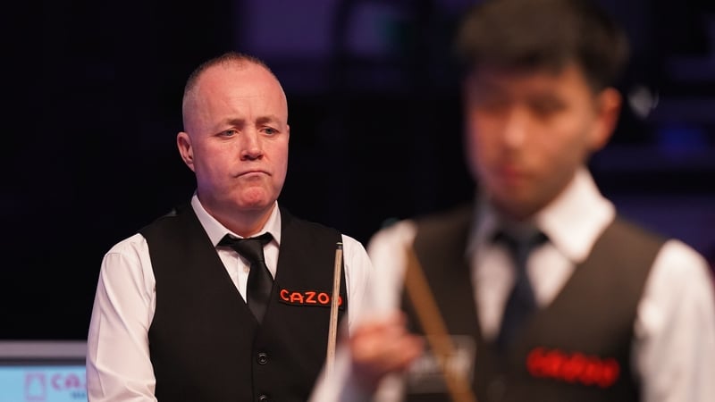 John Higgins eased past Zhao Xintong to reach the second round