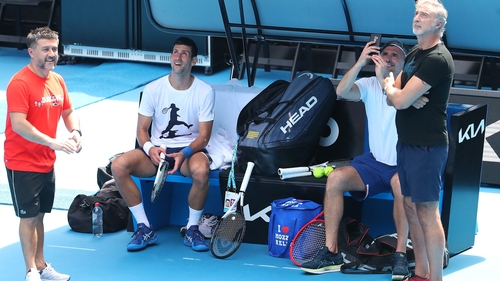 Novak Djokovic and members of his entourage check out a helicopter overhead at Rod Laver Arena