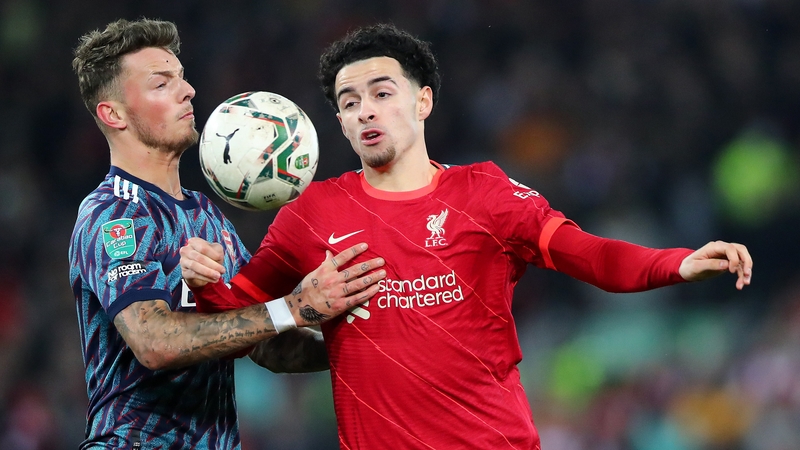 Ben White and Curtis Jones battle for the ball